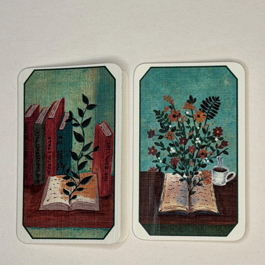Two rectangular art cards with rounded corners displayed side-by-side on a light beige background. The left card features a vintage illustration of books and a plant sprig on a table.